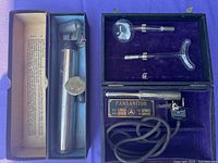 Photo of Pansanitor device case with additional metal medical tool in a separate box.