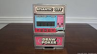 Front view of Atlantic City Draw Poker Machine showing the display screen, control buttons, and coin slot.