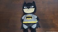 Full body view of Batman plush toy showing front, costume and logo.
