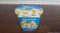 Photo of the top and front of the Daisy Easy to Grow Kit showing daisies and kit details.