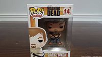 Front view of Daryl Dixon Funko Pop vinyl figure in window display box showing figure and branding number 14 from The Walking Dead.