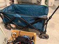 Internal view of the cart with some cables and items inside, showing size and interior space.