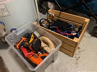 Clear plastic bin with power tools including cordless drill, manual screwdriver, sanding tools and accessories