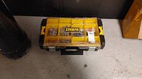 Closed view of the DeWalt yellow and black hardware organizer case with visible compartments and DeWalt logo.