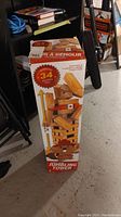 Photo of the boxed giant sized jumbling tower game showing the height and packaging with cartoon beaver character.