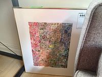 Full view of framed print showing the colorful collage of vintage postage stamps.