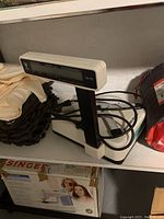 Side view of the Digi DS-782 digital scale on a shelf, showing the platform and upright display.