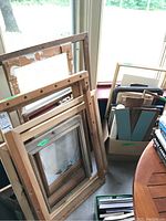 Frames stacked together showing various wooden frame sizes and conditions