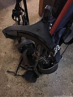Close-up photo of the golf bag and part of the trolley base showing wheels and frame