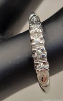 Close-up of ring band showing diamond setting and 18kt stamp