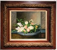 Full view of framed oil painting depicting floral still life in ornate carved wood frame.