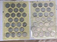 Two pages of US State Quarters taped in holders, showing 51 coins in total.