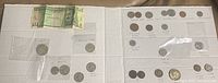 Overview of all coins and the single banknote included in the lot on a white background.