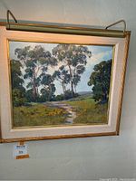 Painting and frame with attached lamp, full view