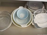 Top view showing multiple bowls and containers including glass, ceramic, and plastic.