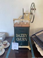 Front view of complete churn showing enamel canister, wooden lid, porcelain knobs and front spigot