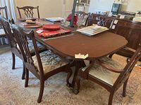 Overview of dining table with eight chairs and table pads