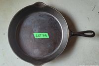Top view of cast iron frying pan showing round cooking surface and pouring spouts.