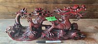 Full side view of the large dragon figure showing detailed scales, claws, and base texture