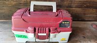 Closed red and beige plastic tackle box with white handle placed on wooden surface, labeled 'One Tray Box'