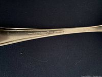 Close-up photo showing the silverware hallmarks stamped on the handle indicating it is made in Germany.