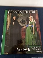 Cover of the hardcover art book showing Flemish artwork and the title 'Grands Peintres Van Eyck' with listed painters.