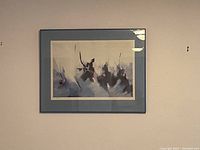 Photo of framed abstract art print featuring dark, smokey organic shapes with a muted background and a blue-grey matte.