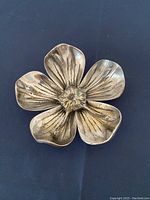 Top view of assembled silver-plated lotus flower ashtray showing wear and tarnish.