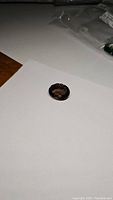 Photo showing oval cut smokey quartz gemstone on white paper background.