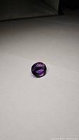 Photo showing the deep rich purple color and cabochon cut of the large amethyst gemstone.