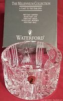 Photo of Waterford Irish Crystal champagne bottle coaster with original box showing Millennium Collection box with toasts text.