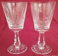 Pair of Kenmare pattern Waterford Irish Crystal claret wine glasses standing side by side showing detailed cut crystal design, faceted stems, and round bases.