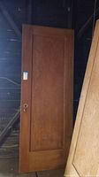 Full front view of the Douglas Fir wood door with rectangular recessed panel and knob hole visible on the left side.