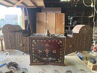 Wide angle photo of the handmade Turkish shoe shine kit showing copper panels, wooden base with mother of pearl inlay, two cylindrical footrests, and central drawer with metal handle.