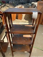 Front view of the vintage wooden shelf showing four shelves.
