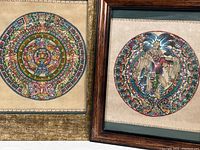 Pair of framed Aztec-themed prints side by side, showing detailed designs and frame styles.