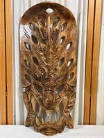 Front view of the carved wooden dragon mask showing full face, carving details and overall shape.