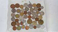 Top view of 43 assorted coins in various sizes and colors showing diversity in origins and conditions.