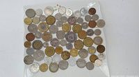 Top view of the assorted coins laid out on a transparent surface showing various sizes and colors