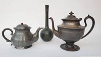 Front view of the three items showing shape and finishes of vase, teapot, and coffeepot
