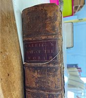 Close-up of spine showing gilt label reading 'Raleigh’s Hist. of the World' and leather wear