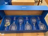 Five pairs of crystal goblets with a cut design and silver rims, packed in a blue Schott Zwiesel branded box with individual slots for each glass.