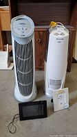 Front view showing Honeywell humidifier, Envirnizer air cleaner, Sylvania digital frame and standard frame on floor