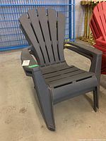 Front view of a dark gray resin Adirondack chair showing slatted back, seat, and wide armrests