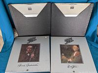 Two 'Giants of Jazz' vinyl box sets showing portraits of Frank Teschmacher and Earl Hines on front covers.