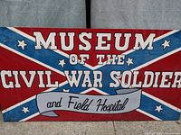 Close-up photo of the painted sign showing the text 'Museum of the Civil War Soldier and Field Hospital' with a Confederate battle flag style background.