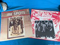 Front covers of two vinyl record albums for sale, one from The Ink Spots and one from Louis Jordan.