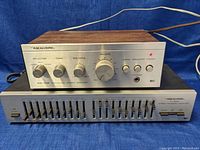 Realistic SA-102 integrated amplifier atop Realistic ten band frequency equalizer showing full front panels and control layout