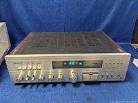 Front view of Realistic STA 2250 stereo receiver with control knobs and digital frequency display showing 88.1 MHz FM.
