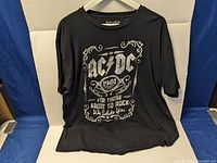 Black vintage AC/DC T-shirt with front print showing 1981 graphic and text 'For Those About To Rock We Salute You'